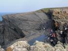 Amphitheatre in cliff tops on south side of Trusklieve slot exposes Tullig Formation Upper Carboniferous or Namurian age, delta front. Top of cliff the section is channelled and quartzose sands have been sorted by waves that impinged on the delta front and filled distributary channels and/or proximal bar sands (Andy Pulham personal communication and Martinsen et al., 2008).