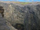 Tullig Formation channel fill sands of Upper Carboniferous or Namurian age. Channeling and sorting of the quartz rich character of the sands of the delta front reflect waves impinging on the delta front sands that filled distributary channels and/or proximal bar sands (Andy Pulham personal communication and Martinsen et al., 2008). In forground are rhymically bedded silts and muds of marine bay fill, probably within wave base.