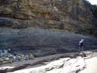 Top of cliff are Tullig Formation channel fill sands of Upper Carboniferous or Namurian age that reflect the effect of waves impinging on the delta front sands (Andy Pulham personal communication and Martinsen et al., 2008). Below are rhythmic silts and muds in deeper water but within wave base.